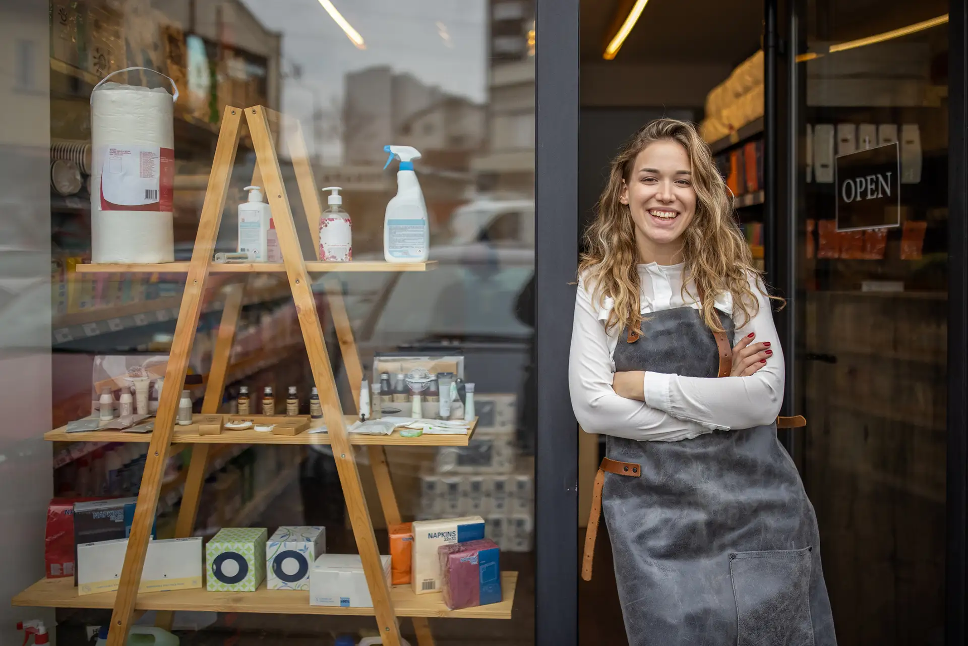 lady standing by her clean retail window
